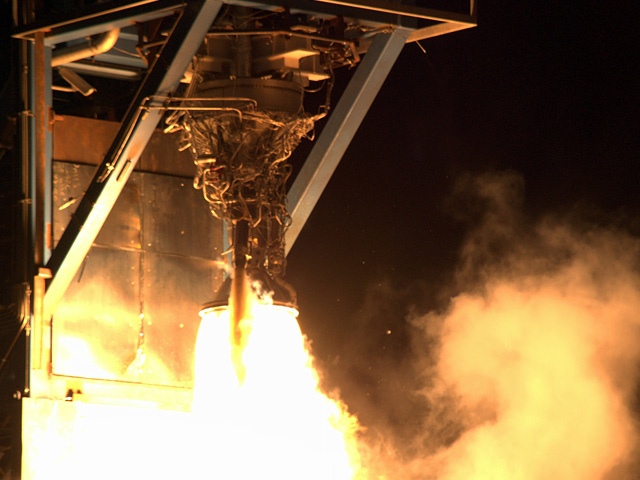 20090616_mvac Merlin Vacuum (MVac) engine firing on the test stand in Texas. Like the smaller engine on our Falcon 1 second stage, during flight the MVac engine will also have a large radiatively cooled expansion nozzle to increase its performance in the vacuum of space.