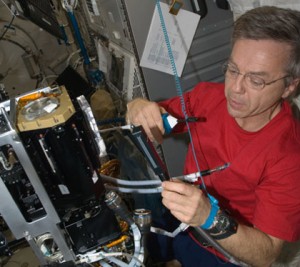 160328main_420x374 Image Above: Expedition 20 Flight Engineer Robert Thirsk works with hardware in the Kibo laboratory of the International Space Station. Credit: NASA
