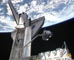 368958main_icc The Integrated Cargo Carrier is transferred from space shuttle Endeavour’s cargo bay by the shuttle's Canadarm robotic arm. Photo credit: NASA TV
