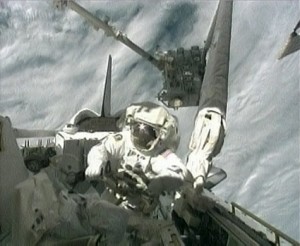 368958main_kopra_kibo Spacewalker Tim Kopra works in the payload bay of space shuttle Endeavour as the International Space Station’s Canadarm2 robotic arm hands the Japanese Exposed Facility to the shuttle’s Canadarm robotic arm. Photo credit: NASA TV
