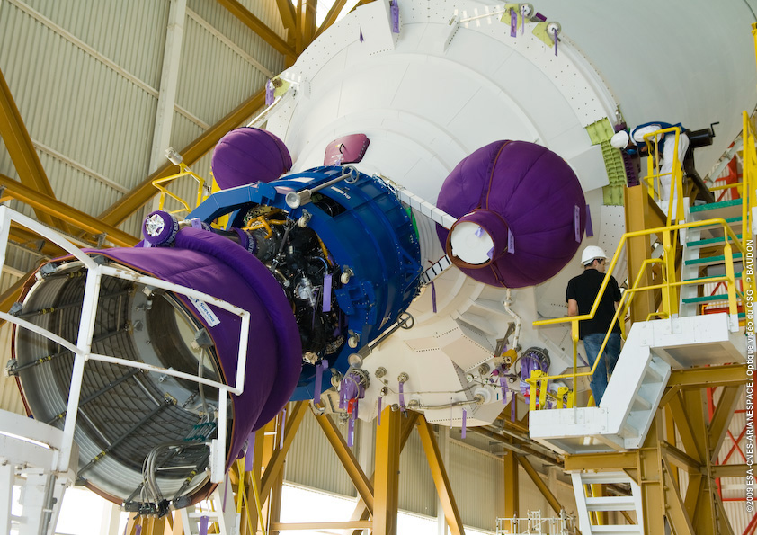 616_1_lg This close-up image shows the Ariane 5’s core cryogenic stage being raised into the vertical position after being removed from its shipping container. The core stage is then hoisted into position over Ariane 5’s mobile launch table inside the Launcher Integration Building, allowing the two solid boosters to be mated with it.