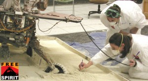 Mars Exploration Rover team members at NASA's Jet Propulsion Laboratory, Pasadena, Calif., prepare an experiment on July 13, 2009, for assessing how a test rover moves when embedded in loose soil and commanded to drive backward with wheels turned.