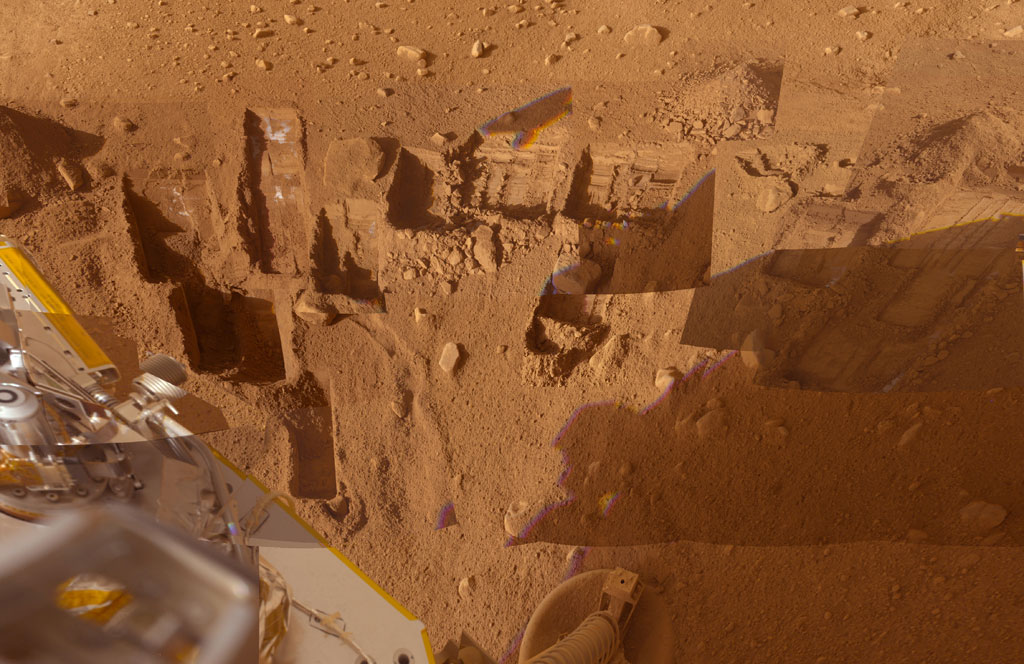 phx17062-full This mosaic of images from the Surface Stereo Imager camera on NASA's Phoenix Mars Lander shows several trenches dug by Phoenix, plus a corner of the spacecraft's deck and the Martian arctic plain stretching to the horizon. Image Credit: NASA/JPL