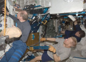 160328main_iss020e031126 Expedition 20 flight engineers Frank De Winne (left), Tim Kopra (foreground) and Michael Barratt work in the Unity node of the International Space Station. Photo credit: NASA