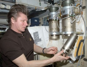 160328main_iss020e031128 Expedition 20 Commander Gennady Padalka performs a check on an air filter unit in the Zvezda service module of the International Space Station. Credit: NASA