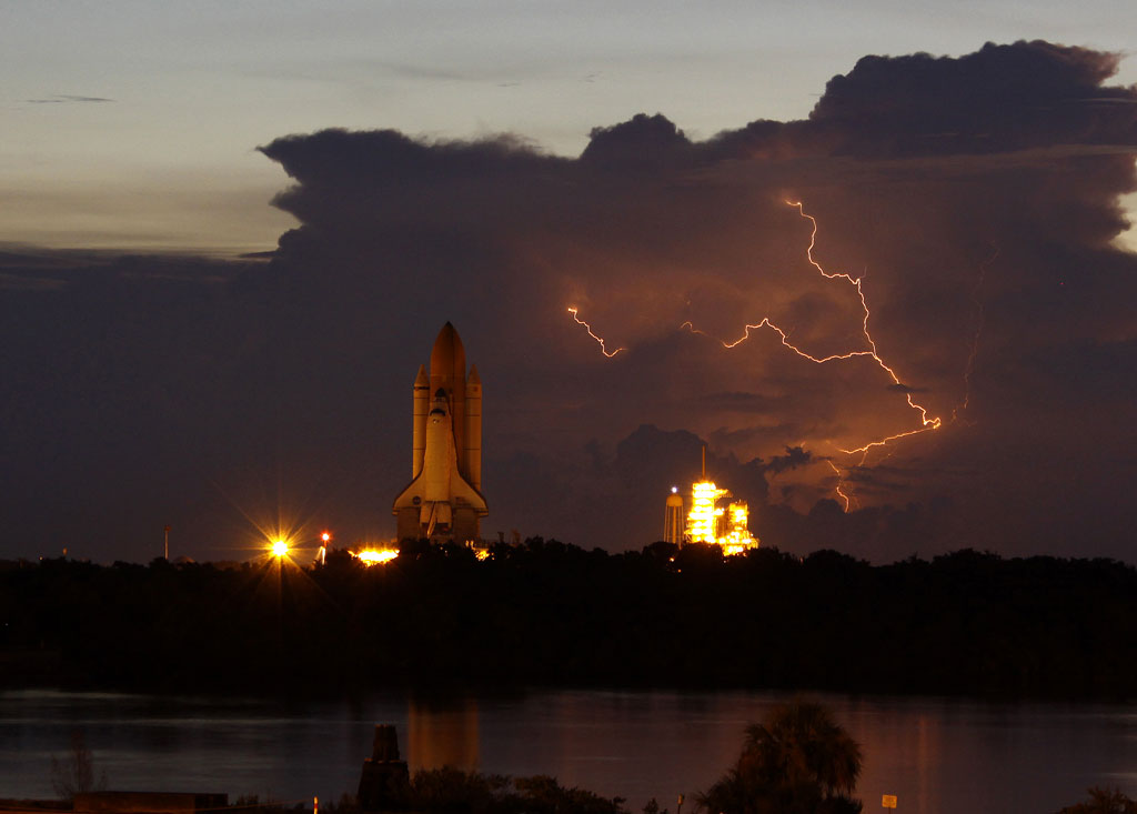 180842main_shutrolloutlight Lightning makes a dramatic background and slows the rollout of space shuttle Discovery to Launch Pad 39A at NASA's Kennedy Space Center in Florida on Tuesday. First motion of the shuttle out of the Vehicle Assembly Building was at 2:07 a.m. Photo credit: Courtesy of Justin Dernier