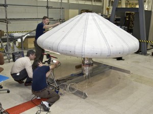 377623main_irve-01 NASA engineers check out the Inflatable Re-entry Vehicle Experiment (IRVE) in the lab. Credit: NASA/Sean Smith