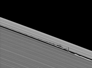 5682_13083_1 Vertical structures created by Saturn's small moon Daphnis cast long shadows across the rings in this dramatic image taken as the planet approaches its mid-August 2009 equinox.