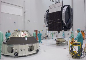 621_1_lg Optus D3 is positioned for installation on its interface adapter unit inside the S5 payload preparation facility.