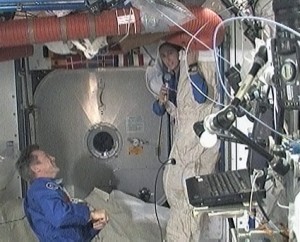 160328main_092309 Flight Engineers Robert Thirsk (left) and Nicole Stott demonstrate sleeping conditions aboard the International Space Station while answering questions from students in Vulcan, Alberta. Credit: NASA TV