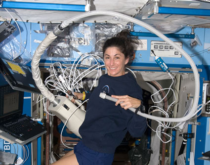 160328main_iss020e039751 Flight Engineer Nicole Stott uses a vacuum cleaner in the Destiny laboratory of the International Space Station. Credit: NASA