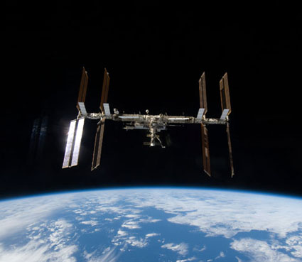 160328main_s128e009800 Backdropped by Earth’s horizon and the blackness of space, the International Space Station is seen from space shuttle Discovery after undocking. Credit: NASA