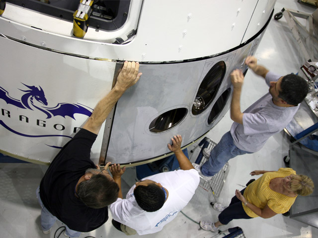 20090922_dragonpanels2 Test fitting the thermal protection panels that surround the thrusters on the Dragon qualification capsule. The panels must be strong, lightweight, and able to withstand the extreme conditions of space, as well as perform in close proximity to the operating thrusters.
