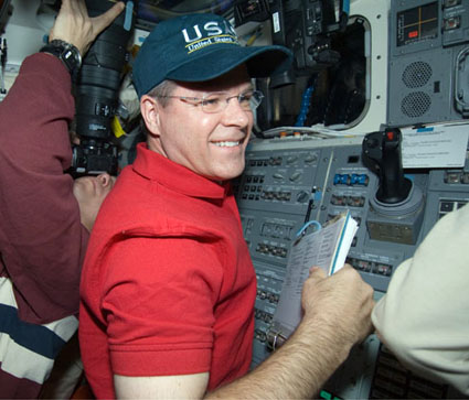 382012main_s128e009965 Pilot Kevin Ford (right) and Mission Specialist Tim Kopra work on the aft flight deck of space shuttle Discovery. Credit: NASA