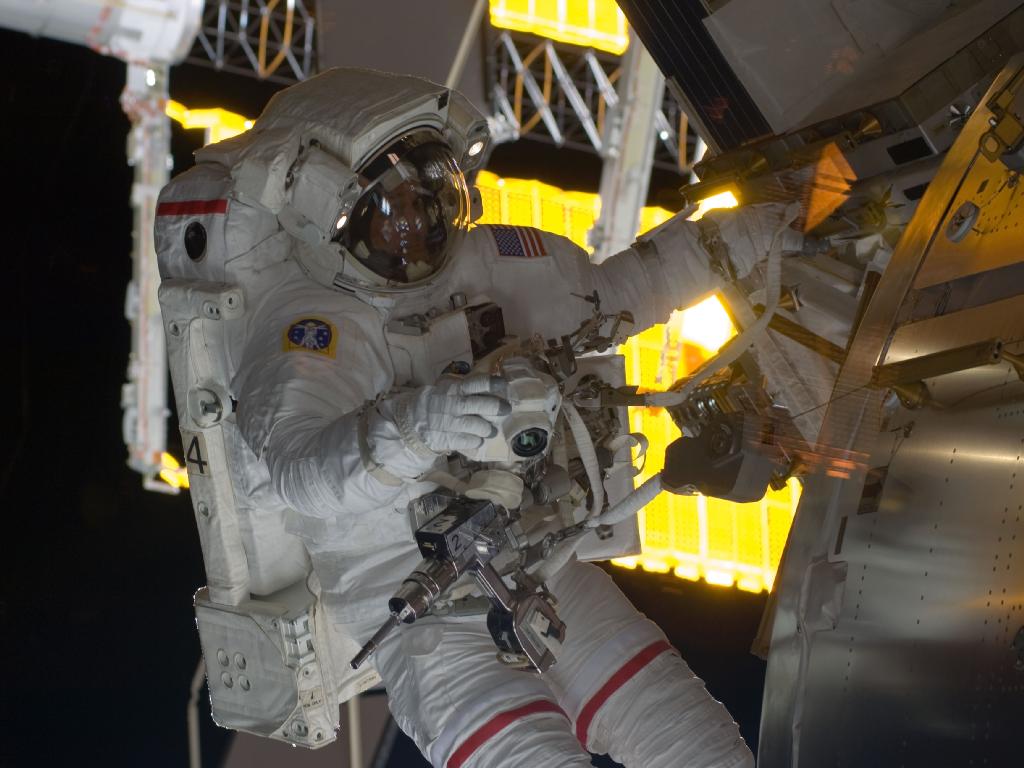 383062main_1460_1024-768 Discovery spacewalker Danny Olivas at work during the STS-128 mission's first spacewalk. (Credit:NASA)