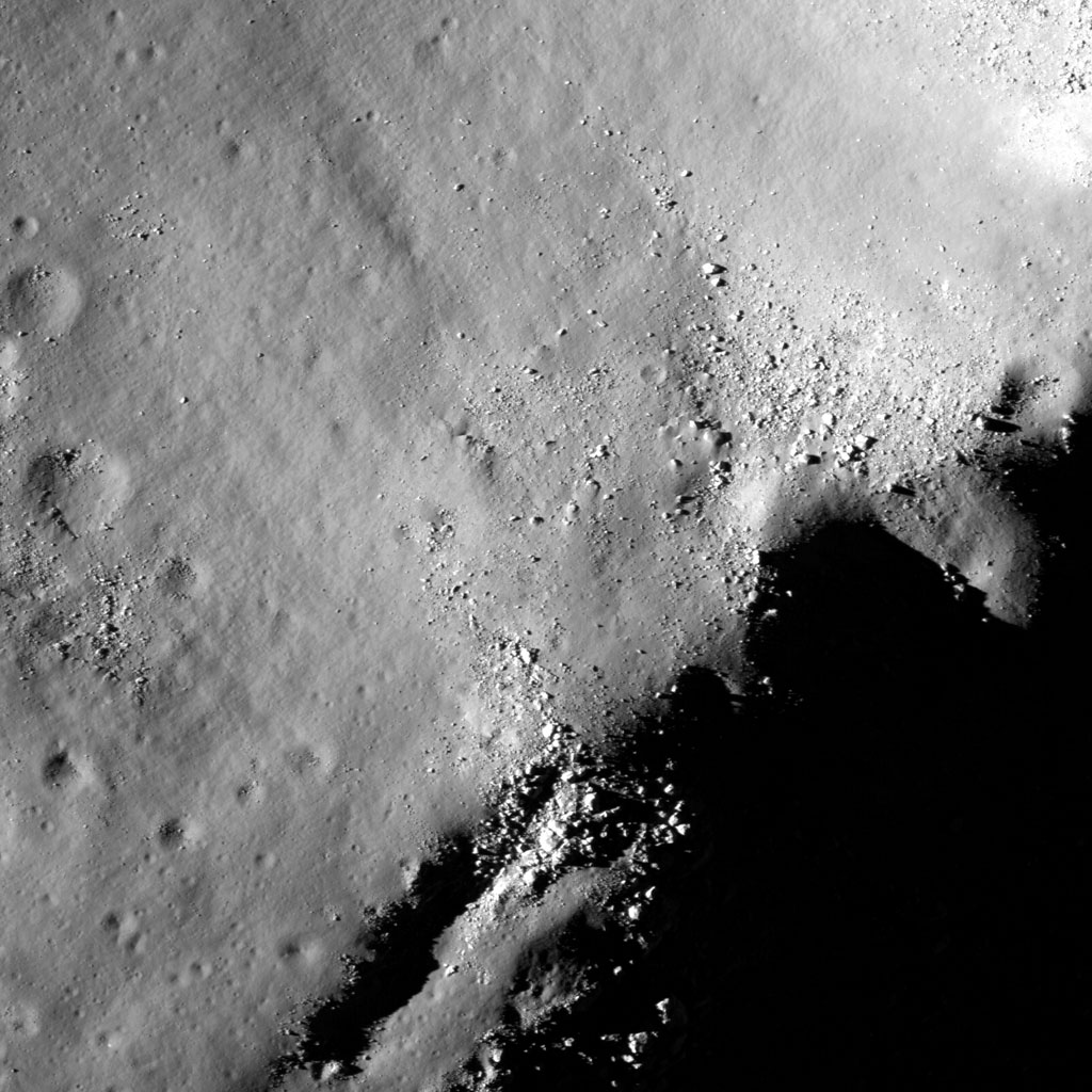 383218main_tsiolkovskiy_200 This image shows boulders perched on the summit of the central peak of the 185-km-wide (115 miles) Tsiolkovskiy Crater. This close-up image is about 14.4 km (9 miles) wide. North is toward the top of the image. Credit: NASA/Goddard Space Flight Center/Arizona State University