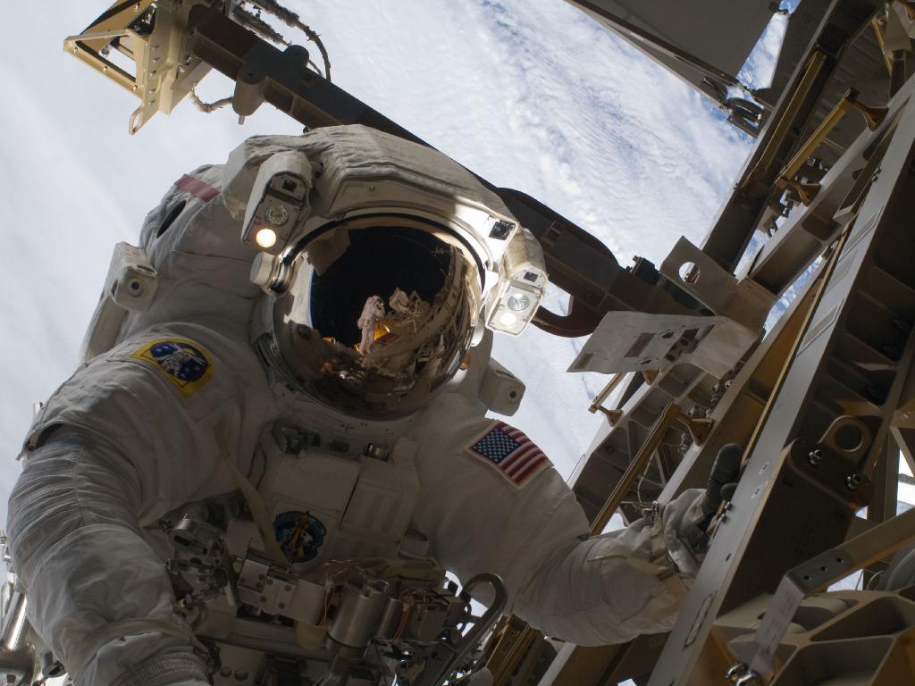 384475main_image_1463_1024-768 Christer Fuglesang Reflected in Danny Olivas's helmet visor. Credit: NASA