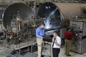 384775main__DSC0020 Marshall's one of a kind test facility enabled engineers to simulate the nuclear power process of heat transfer from a reactor to a power converter. Boise Pearson (Left), Team Lead for Fission Surface Power Test Facility and Mike Houts Project Manager for nuclear systems at Marshall review test results on the Stirling engine. Kurt Polzin, research scientist is shown in background. Image credit: NASA/MSFC/E. Given