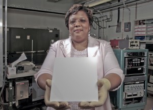 Wanda Peters holds some material with the lotus coating on it. Credit: NASA