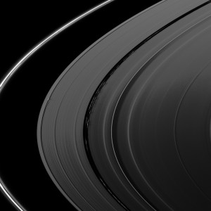 387978main_PIA11676-full Near the middle of the image, shadows are cast by vertically extended clumps in the kinky, discontinuous ringlets of the Encke Gap in the A ring. These clumps are casting shadows approximately 275 kilometers (170 miles) long, implying a clump height about 600 meters (2,000 feet) above the ring plane. Credit:NASA