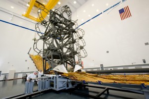 388197main_JWST0021-9126_full This photograph shows simulators of the James Webb Space Telescope's optical telescope element and the sunshield's integrated validation article, mated together in Northrop Grumman's high bay in Space Park. The simulators are used to check that the actual telescope components will fit properly when installed on the real thing. Credit: Northrop Grumman