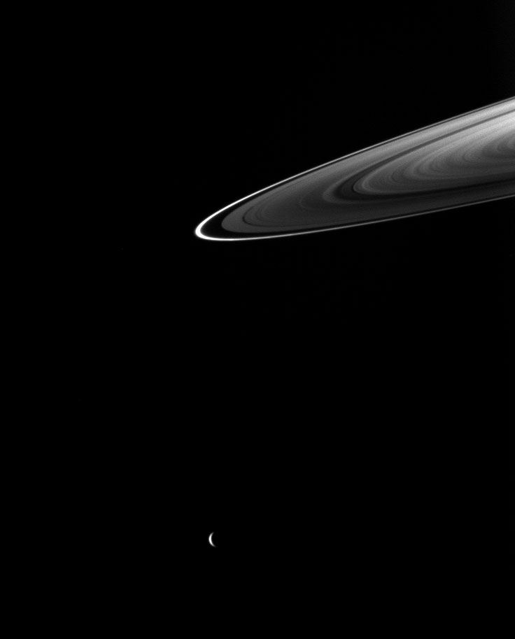 5808_13661_2 Rhea (1528 kilometers, 949 miles across) is near the middle of the bottom of the image. This view looks toward the northern, sunlit side of the rings from about 4 degrees above the ringplane.