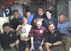 160328main_jointcrew3 All nine residents of the International Space Station talk to news media. In the from front row from left to right are Commander Gennady Padalka, spaceflight participant Guy Laliberté, and Flight Engineers Frank De Winne and Michael Barratt. Behind them from left to right are Flight Engineers Robert Thirsk, Roman Romanenko, Maxim Suraev, Nicole Stott and Jeffrey Williams. Credit: NASA TV