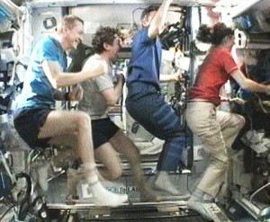160328main_station_100109 Four Expedition 20 flight engineers pretend to run on the International Space Station’s new COLBERT treadmill. From left, they are Frank De Winne, Michael Barratt, Robert Thirsk and Nicole Stott. Credit: NASA TV