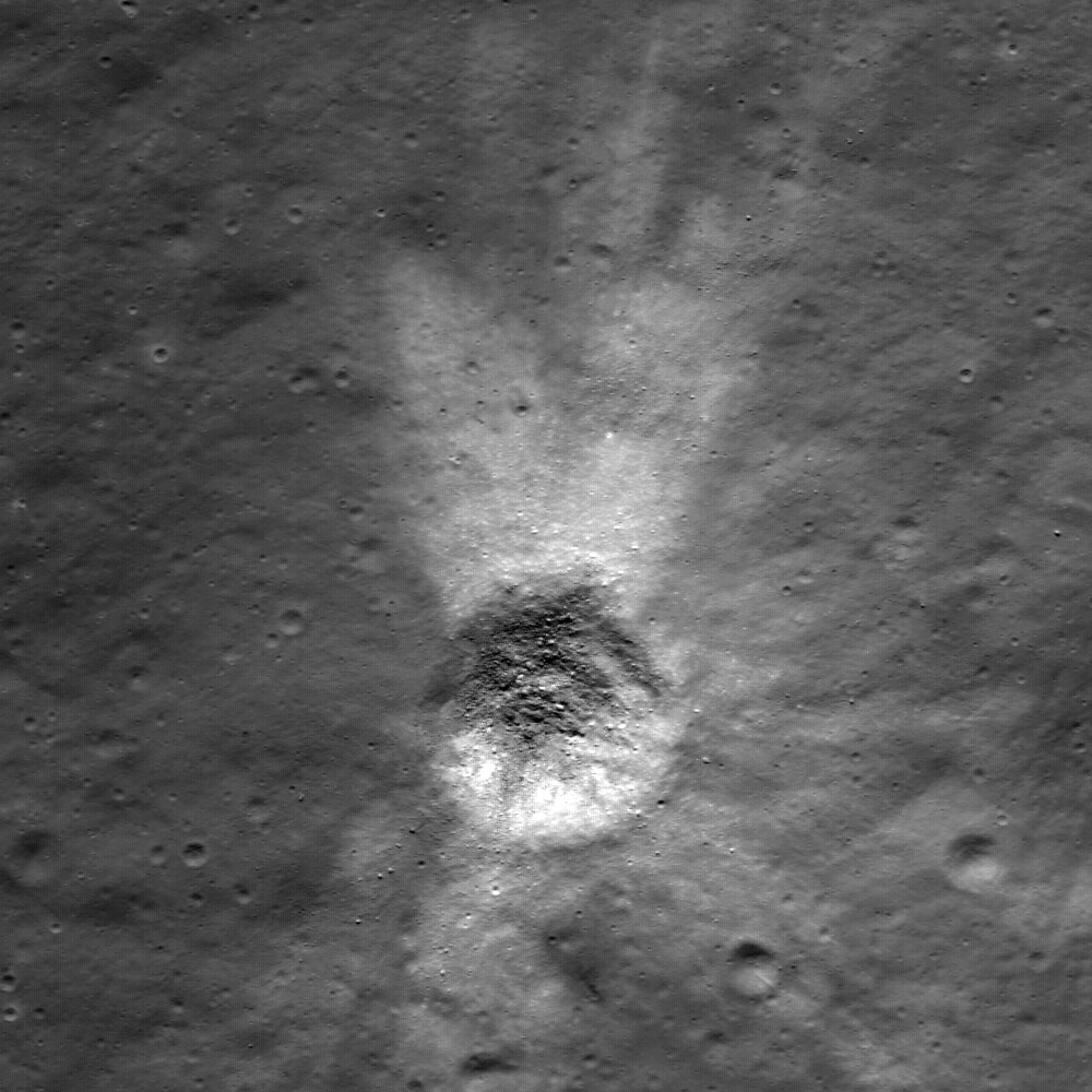 Distinctive asymmetrical ejecta surrounds a 140 meter (459 feet) diameter crater in the lunar highlands. The crater is located on the northeastern rim of the eroded crater Hommel. Image width is 600 meters (1,969 feet). The top of the image faces north. Credit: NASA Distinctive asymmetrical ejecta surrounds a 140 meter (459 feet) diameter crater in the lunar highlands. The crater is located on the northeastern rim of the eroded crater Hommel. Image width is 600 meters (1,969 feet). The top of the image faces north. Credit: NASA
