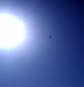 Xombie Craft captured by a cellphone hovering in front of the sun