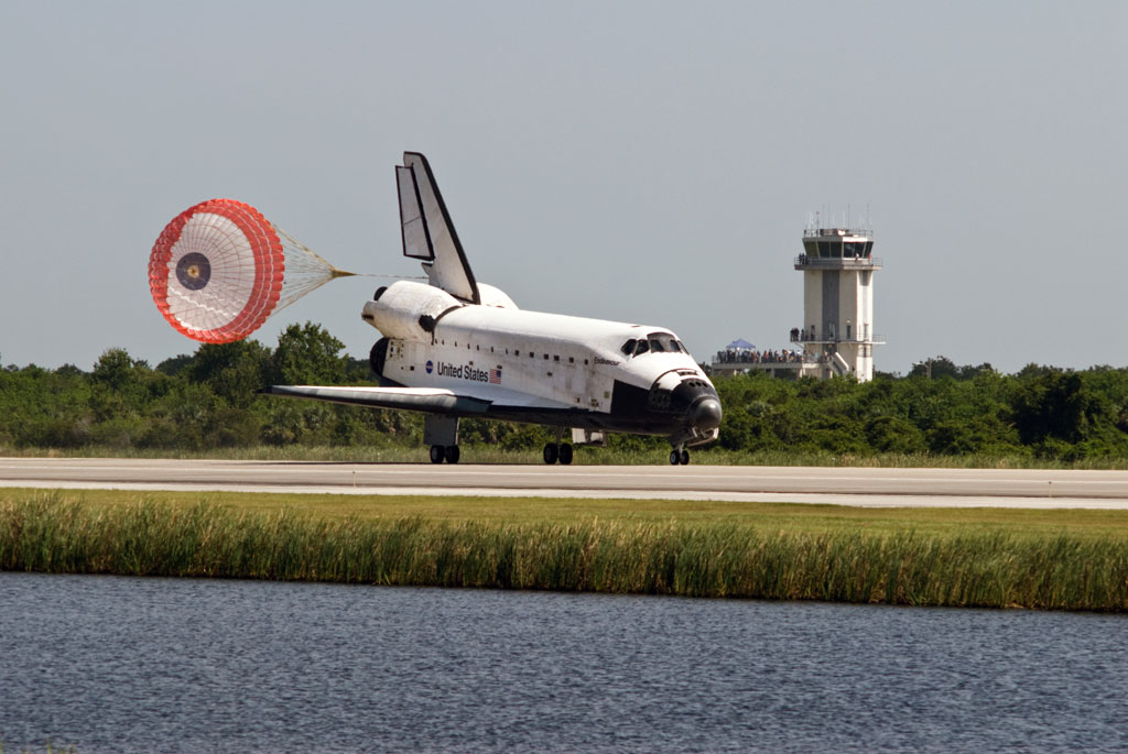 Space shuttle Endeavour rolls down the Shuttle Landing Facility runway past the air traffic control tower. The tower is about 100 feet above the 3-mile-long runway and affords controllers working inside a clear view of the SLF and much of the Kennedy Space Center area. They also have radar and other technology to watch the airspace around the center. Credit: NASA Space shuttle Endeavour rolls down the Shuttle Landing Facility runway past the air traffic control tower. The tower is about 100 feet above the 3-mile-long runway and affords controllers working inside a clear view of the SLF and much of the Kennedy Space Center area. They also have radar and other technology to watch the airspace around the center. Credit: NASA