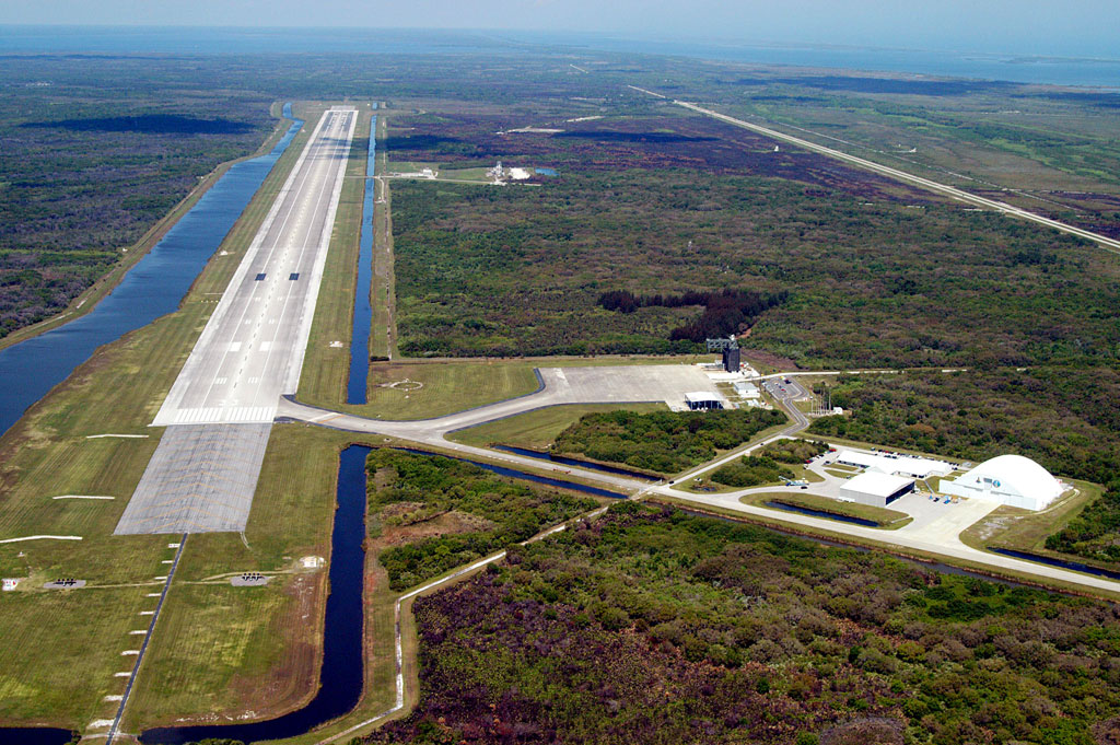 At 3 miles in length and about 100 yards in width, the SLF is one of the largest runways ever built. The black boxes painted on the concrete are the preferred touchdown points for a shuttle returning from space. The SLF complex includes a hangar, control tower, fire station and ramp facilities. Credit: NASA At 3 miles in length and about 100 yards in width, the SLF is one of the largest runways ever built. The black boxes painted on the concrete are the preferred touchdown points for a shuttle returning from space. The SLF complex includes a hangar, control tower, fire station and ramp facilities. Credit: NASA