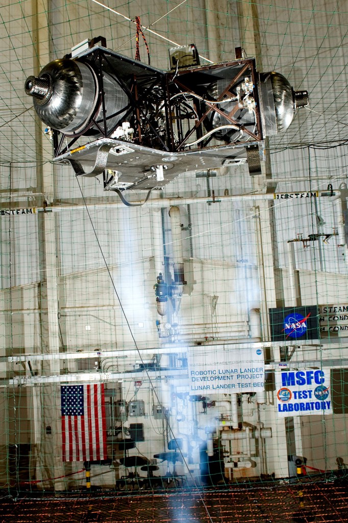 The robotic lunar lander test article is released from its hoist in preparation for a controlled landing. Credit: NASA/MSFC/David Higginbotham The robotic lunar lander test article is released from its hoist in preparation for a controlled landing. Credit: NASA/MSFC/David Higginbotham