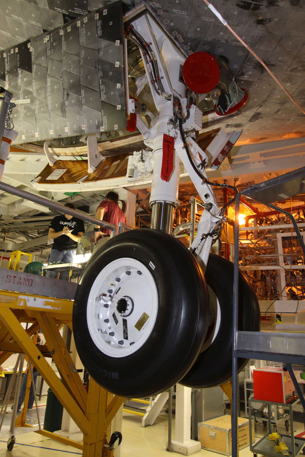 In Orbiter Processing Facility-2 at NASA's Kennedy Space Center in Florida, workers verify that the processing of space shuttle Endeavour is complete, its payload bay doors are closed, and it is ready for its move to the Vehicle Assembly Building. This close-up is of Endeavour's nose-wheel landing gear and tires. Photo credit: NASA In Orbiter Processing Facility-2 at NASA's Kennedy Space Center in Florida, workers verify that the processing of space shuttle Endeavour is complete, its payload bay doors are closed, and it is ready for its move to the Vehicle Assembly Building. This close-up is of Endeavour's nose-wheel landing gear and tires. Photo credit: NASA
