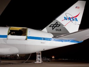392080main_ED09-0279-07c_946-710 The rear fuselage of the Stratospheric Observatory for Infrared Astronomy's 747SP is illuminated during telescope testing operations in preparation for aircraft and science checkout flights. The telescope cavity door is open with the lower flexible door partially extended.