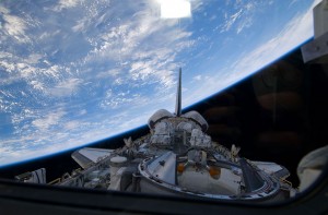 Backdropped by Earth's horizon, a partial view of Atlantis' payload bay, vertical stabilizer, orbital maneuvering system pods and docking mechanism are featured in this image. Credit: NASA Backdropped by Earth's horizon, a partial view of Atlantis' payload bay, vertical stabilizer, orbital maneuvering system pods and docking mechanism are featured in this image. Credit: NASA