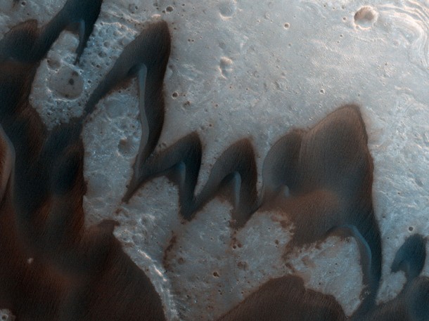 This HiRISE image shows an example of several barchans merging to form an even larger barchan dune. Credit: NASA This HiRISE image shows an example of several barchans merging to form an even larger barchan dune. Credit: NASA