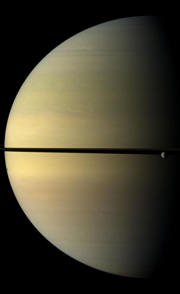 Saturn, stately and resplendent in this natural color view, dwarfs the icy moon Rhea. Credit: NASA Saturn, stately and resplendent in this natural color view, dwarfs the icy moon Rhea. Credit: NASA