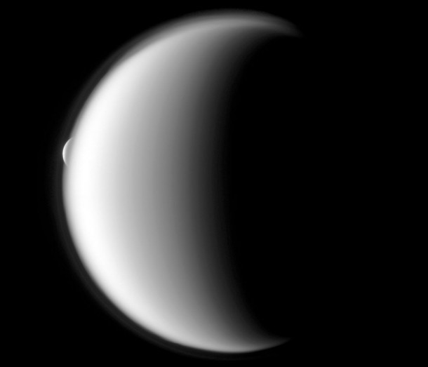 Rhea emerges after being occulted by the larger moon Titan. Credit: NASA