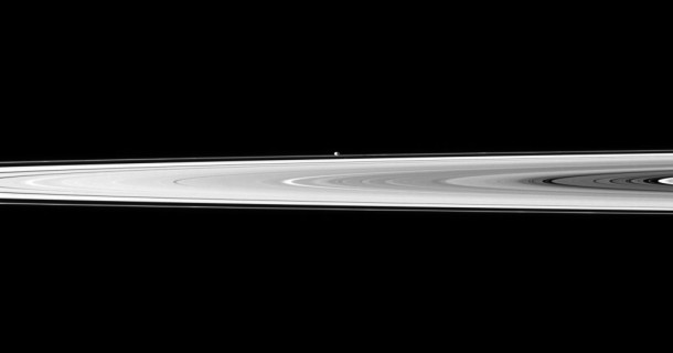 The tiny moon Pandora appears beyond the bright disk of Saturn's rings. Credit: NASA