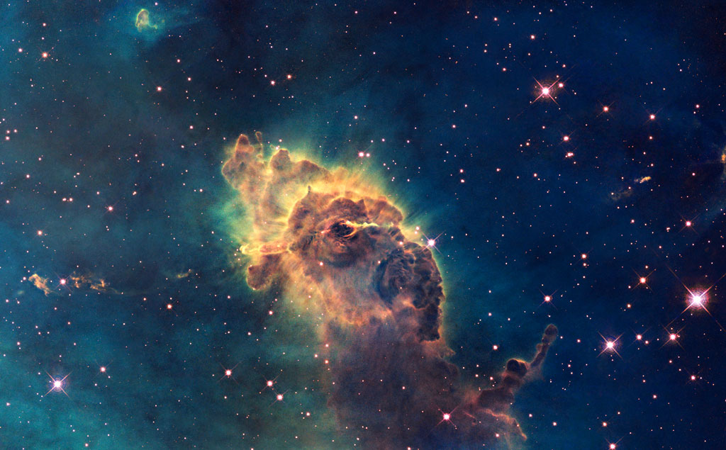 A pillar of gas in the Carina Nebula is bathed in the light of hot, massive stars. Credit: NASA, ESA A pillar of gas in the Carina Nebula is bathed in the light of hot, massive stars. Credit: NASA, ESA