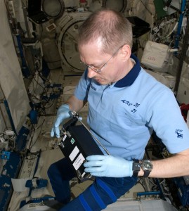 Frank De Winne working with RadSilk experiment. Credit: NASA