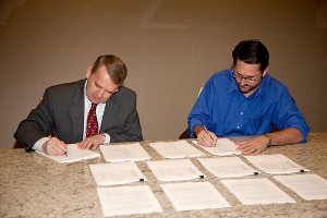 Dr. Marc Bendickson (left), Dynetics CEO, and Tim Pickens, founder of Orion Propulsion (OPI), finalize the purchase of OPI by Dynetics. Dr. Marc Bendickson (left), Dynetics CEO, and Tim Pickens, founder of Orion Propulsion (OPI), finalize the purchase of OPI by Dynetics.