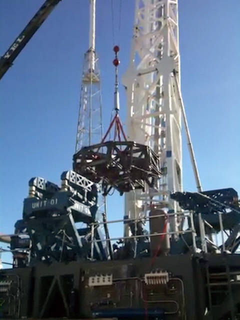 Launch mount system test, with a crane pulling up on a Falcon 9 engine mount truss to simulate the forces it will experience at liftoff. After releasing the rocket, the mount towers move back to give maximum clearance to the departing vehicle. Credit: SpaceX Launch mount system test, with a crane pulling up on a Falcon 9 engine mount truss to simulate the forces it will experience at liftoff. After releasing the rocket, the mount towers move back to give maximum clearance to the departing vehicle. Credit: SpaceX