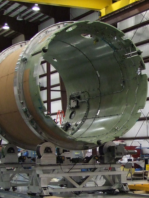 The Falcon 9 flight interstage in the Cape Canaveral launch site hangar prior to mating with the first stage. Credit: SpaceX. The Falcon 9 flight interstage in the Cape Canaveral launch site hangar prior to mating with the first stage. Credit: SpaceX.