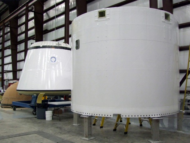 First flight Dragon nosecone (tan, at left), spacecraft (middle) and trunk (right) in process at the SLC-40 launch pad hangar in Florida. Photo credit: SpaceX. First flight Dragon nosecone (tan, at left), spacecraft (middle) and trunk (right) in process at the SLC-40 launch pad hangar in Florida. Photo credit: SpaceX.