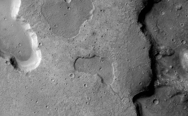 Channel connecting depressions in bottom right providing clear evidence of liquid exchange between depressions. Credit: NASA Channel connecting depressions in bottom right providing clear evidence of liquid exchange between depressions. Credit: NASA