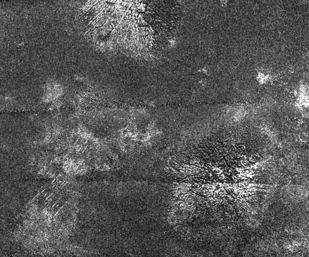 In this synthetic aperture radar image obtained by NASA's Cassini spacecraft, two generally similar features, upper center and lower right, appear to be low mountains with grooves running roughly in the up-down direction. Image credit: NASA/JPL In this synthetic aperture radar image obtained by NASA's Cassini spacecraft, two generally similar features, upper center and lower right, appear to be low mountains with grooves running roughly in the up-down direction. Image credit: NASA/JPL