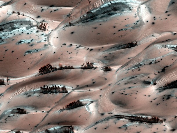 Falling Material Kicks Up Cloud of Dust on Dunes. Credit: NASA/JPL