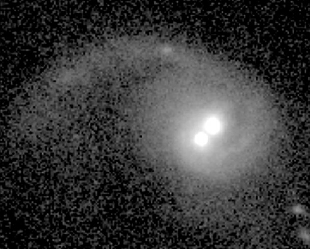 A team of astronomers discovered that the two bright nuclei near the center of this galaxy correspond to two supermassive black holes shining as AGNs. Credit: NASA/ESA A team of astronomers discovered that the two bright nuclei near the center of this galaxy correspond to two supermassive black holes shining as AGNs. Credit: NASA/ESA